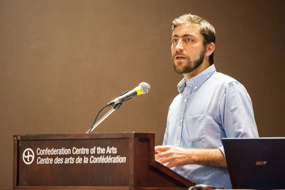 Eric speaking at a lectern