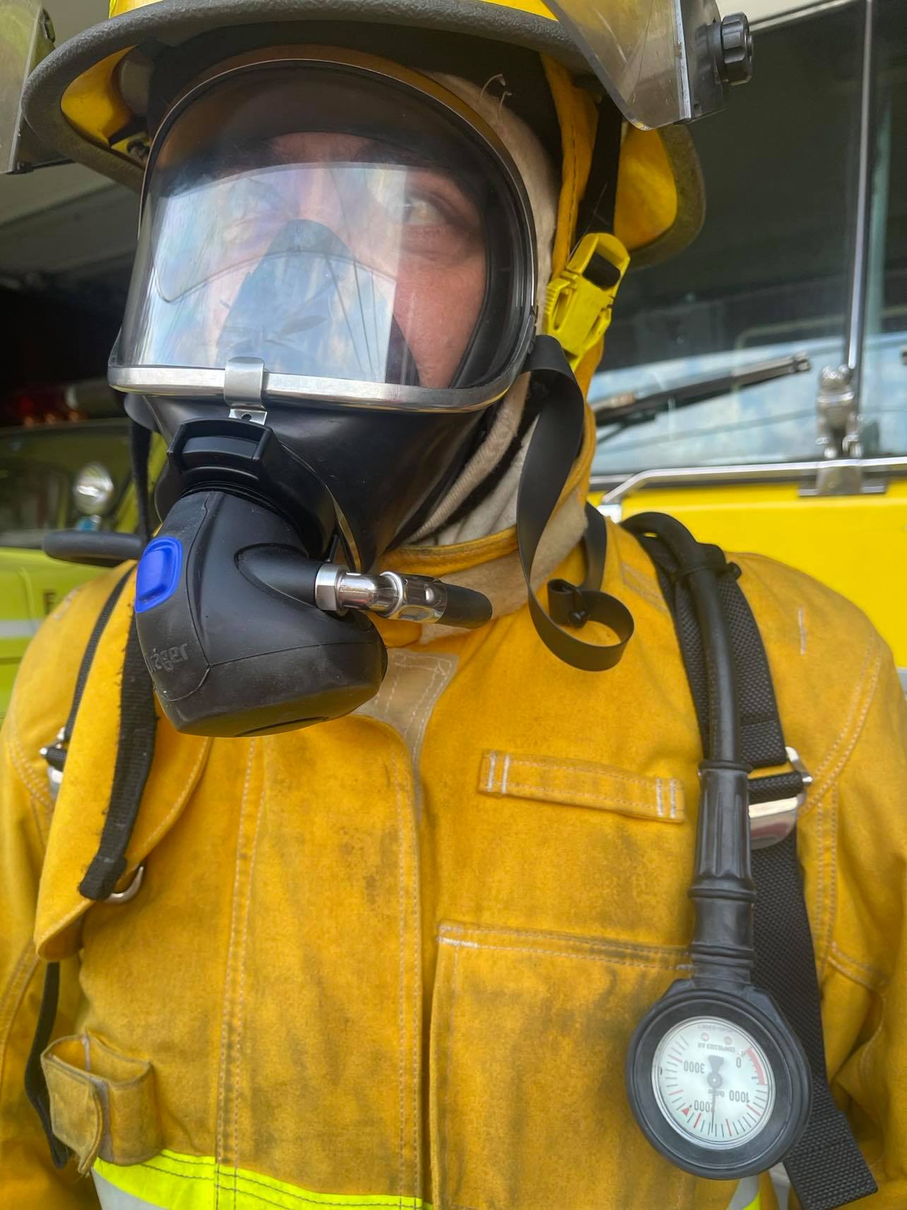 Eric wearing a helmet, breathing apparatus and firefighting coat