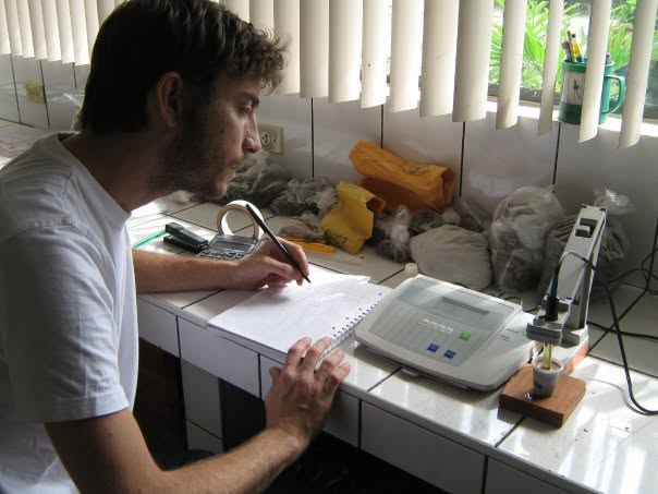 Eric taking notes beside laboratory equipment